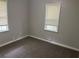 Empty bedroom with neutral walls, carpets and two windows at 2076 Garden Cir, Decatur, GA 30032