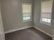 Bedroom with neutral paint and carpet, two windows with blinds and baseboard trim at 2076 Garden Cir, Decatur, GA 30032