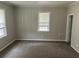 Bedroom with neutral paint and carpet, two windows with blinds and baseboard trim at 2076 Garden Cir, Decatur, GA 30032