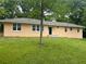 A cozy one-story home with a well-maintained lawn and lots of trees in the background at 2076 Garden Cir, Decatur, GA 30032