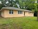 Low angle of a single story home with an orange exterior and many rectangular windows at 2076 Garden Cir, Decatur, GA 30032