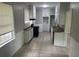 Compact kitchen with wood counters, white cabinets, and a tile floor and backsplash at 2076 Garden Cir, Decatur, GA 30032