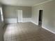 Living room with tile floors, textured half wall, neutral colors, and doorway to another room at 2076 Garden Cir, Decatur, GA 30032