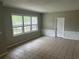 Living room with tile floors, textured half wall, neutral colors, and natural light from three windows at 2076 Garden Cir, Decatur, GA 30032