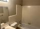 Clean bathroom with a shower-tub combo, neutral tile, and ample lighting at 5703 Kimberly Ln, Norcross, GA 30071
