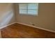 A bedroom with hardwood floors, fresh paint, and a large window at 5703 Kimberly Ln, Norcross, GA 30071