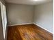 A bedroom with hardwood floors, fresh paint, and a large window at 5703 Kimberly Ln, Norcross, GA 30071