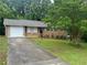 Charming single-story brick home with a well-maintained lawn and attached garage at 5703 Kimberly Ln, Norcross, GA 30071