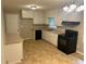 Cozy kitchen with white cabinets, black appliances, and ample counter space at 5703 Kimberly Ln, Norcross, GA 30071
