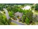 Stunning aerial view of estate home with lush landscaping, golf course, and lake views at 939 Middle Fork Trl, Suwanee, GA 30024