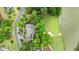 Aerial view of home on golf course with beautiful landscaping and water feature at 939 Middle Fork Trl, Suwanee, GA 30024