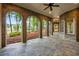 Covered brick patio with arched openings, stone flooring, and views of the lake and surrounding landscape at 939 Middle Fork Trl, Suwanee, GA 30024