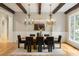 This dining room has wood floors, wooden beams on the ceiling, and large windows with natural lighting at 939 Middle Fork Trl, Suwanee, GA 30024