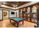 Well-appointed game room with a pool table, display cabinets filled with memorabilia, and access to other areas at 939 Middle Fork Trl, Suwanee, GA 30024