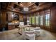 Sophisticated home office with wood paneling, built-in shelves, a large desk, and scenic views of the outdoors at 939 Middle Fork Trl, Suwanee, GA 30024