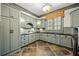 Functional laundry room with ample cabinet space, stylish tile floors, and natural light at 939 Middle Fork Trl, Suwanee, GA 30024