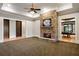 Cozy living room with a stone fireplace, carpet floors, and access to the pool room at 939 Middle Fork Trl, Suwanee, GA 30024