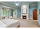Bright main bedroom with a fireplace, natural light, carpet floors, and access to the outside at 939 Middle Fork Trl, Suwanee, GA 30024