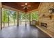Outdoor kitchen and fireplace area with stone flooring, perfect for entertaining and enjoying waterfront views at 939 Middle Fork Trl, Suwanee, GA 30024