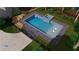 Overhead view of in-ground swimming pool, patio, and landscaping in backyard at 939 Middle Fork Trl, Suwanee, GA 30024
