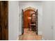 Grand wine cellar entry with wrought iron doors, wood panels, and tile flooring at 939 Middle Fork Trl, Suwanee, GA 30024