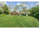 Expansive backyard with lush green lawn, a covered deck, and mature trees at 1436 Diamond Head Drive Dr, Decatur, GA 30033