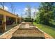 Spacious backyard featuring raised garden beds and a covered deck, perfect for outdoor living at 1436 Diamond Head Drive Dr, Decatur, GA 30033