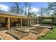 View of the backyard showing raised garden beds, covered deck and access to the home at 1436 Diamond Head Drive Dr, Decatur, GA 30033