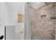 Neutral tile walk-in shower and linen cabinet in a modern bathroom at 1436 Diamond Head Drive Dr, Decatur, GA 30033