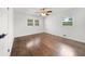 Bedroom featuring hardwood floors, ceiling fan, two windows, and ample natural light at 1436 Diamond Head Drive Dr, Decatur, GA 30033