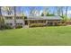 Charming two-story home with a well-manicured front lawn and landscaped bushes and shrubbery at 1436 Diamond Head Drive Dr, Decatur, GA 30033