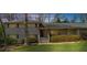Charming two-story home with a well-manicured front lawn, large tree, landscaped bushes and shrubbery at 1436 Diamond Head Drive Dr, Decatur, GA 30033