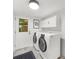 Bright laundry room with white washer, dryer and cabinets for a clean and efficient space at 1436 Diamond Head Drive Dr, Decatur, GA 30033
