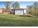 View of the backyard and back of house with a newly constructed wooden deck and stairway at 1931 Selwyn Dr, Decatur, GA 30035