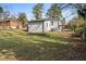 View of the backyard and the back of the house, which features white siding and dark trim at 1931 Selwyn Dr, Decatur, GA 30035