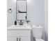 Bathroom with a modern vanity, toilet, and mirror; complemented by stylish black fixtures at 1931 Selwyn Dr, Decatur, GA 30035