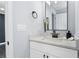 Stylish bathroom featuring a white vanity, quartz countertop, black accents, and modern fixtures at 1931 Selwyn Dr, Decatur, GA 30035