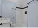 Bathroom featuring a bathtub and shower with modern white and black tiles at 1931 Selwyn Dr, Decatur, GA 30035
