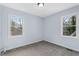 Empty bedroom with neutral carpeting and two windows at 1931 Selwyn Dr, Decatur, GA 30035