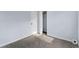 Bedroom with light-blue painted walls and gray carpet, showcasing a closet at 1931 Selwyn Dr, Decatur, GA 30035