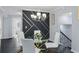Dining area with modern light fixture, round glass table, accent wall, and seamless access to an open staircase at 1931 Selwyn Dr, Decatur, GA 30035