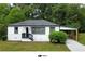 Charming single-story home with fresh white paint, black trim, and a covered carport at 1931 Selwyn Dr, Decatur, GA 30035