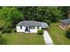 Aerial view of a freshly painted single-story home with lush green lawn and mature trees at 1931 Selwyn Dr, Decatur, GA 30035