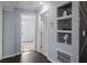 Hallway with a view of the stairway, bedroom, and decorative shelving at 1931 Selwyn Dr, Decatur, GA 30035
