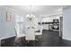 Bright kitchen and dining area featuring white cabinetry, stainless steel appliances, and a glass dining table at 1931 Selwyn Dr, Decatur, GA 30035