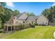 Large home exterior showcasing a spacious deck, lush lawn, and mature landscaping at 240 Rose Ridge Dr, Canton, GA 30115
