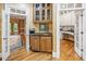 Convenient wet bar area with custom cabinetry, sink, and easy access to the living and dining spaces at 240 Rose Ridge Dr, Canton, GA 30115