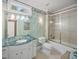 Bathroom features a marble countertop, shower-tub combo with glass doors, and patterned wallpaper at 240 Rose Ridge Dr, Canton, GA 30115