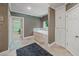 Bathroom featuring a tiled-in bathtub, built-in shelves, and patterned wallpaper at 240 Rose Ridge Dr, Canton, GA 30115