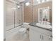 Bathroom features a shower-tub combo, palm tree wallpaper, and marble countertop sink at 240 Rose Ridge Dr, Canton, GA 30115
